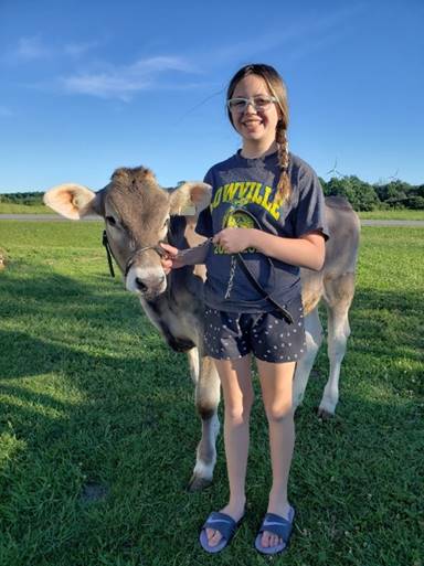 A person holding a cow

Description automatically generated with low confidence