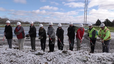 A group of people wearing hardhats and standing in a muddy area

Description automatically generated with medium confidence