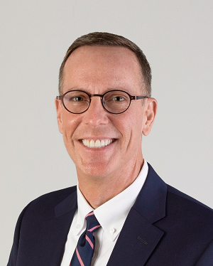 A person wearing glasses and a suit

Description automatically generated with medium confidence