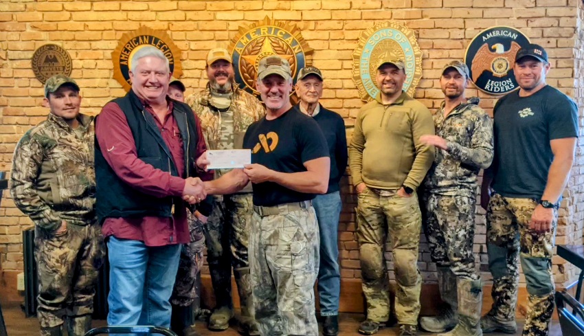A group of men posing for a photo
Description automatically generated with medium confidence