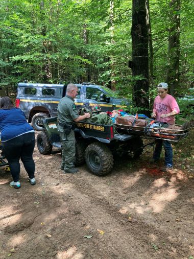 Ranger helps injured hiker strapped onto UTV 