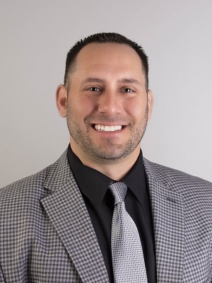 A person in a suit and tie

Description automatically generated with medium confidence