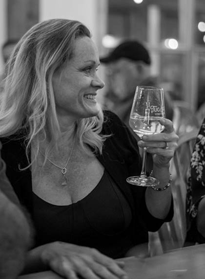 A person holding a glass of wine

Description automatically generated with medium confidence