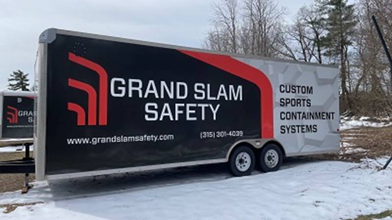 A trailer with a large advertisement on it

Description automatically generated