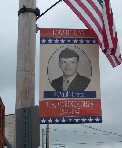 A flag and a sign on a pole

Description automatically generated