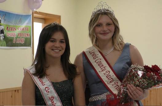 A couple of women wearing sashes

Description automatically generated