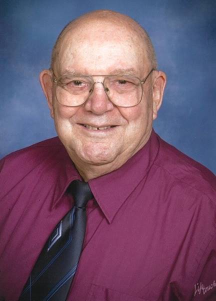 A person wearing a purple shirt and tie

Description automatically generated