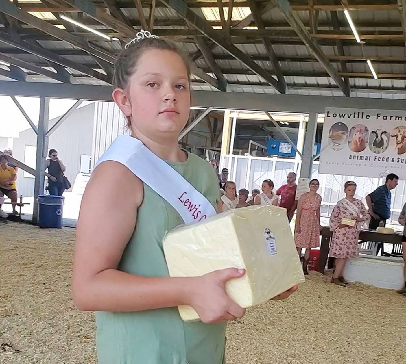 A child holding a block of cheese

Description automatically generated