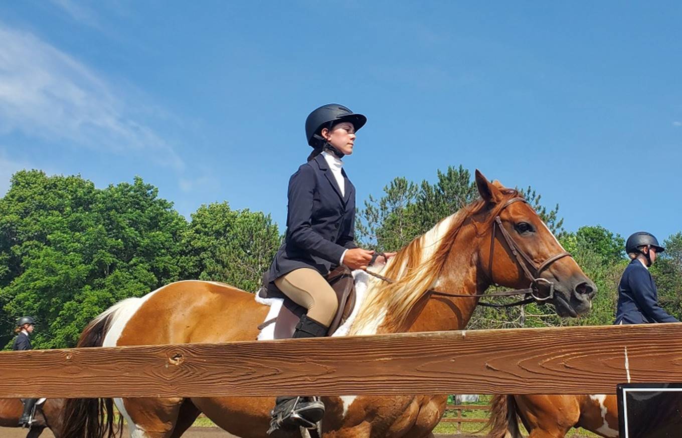 A person riding a horse

Description automatically generated