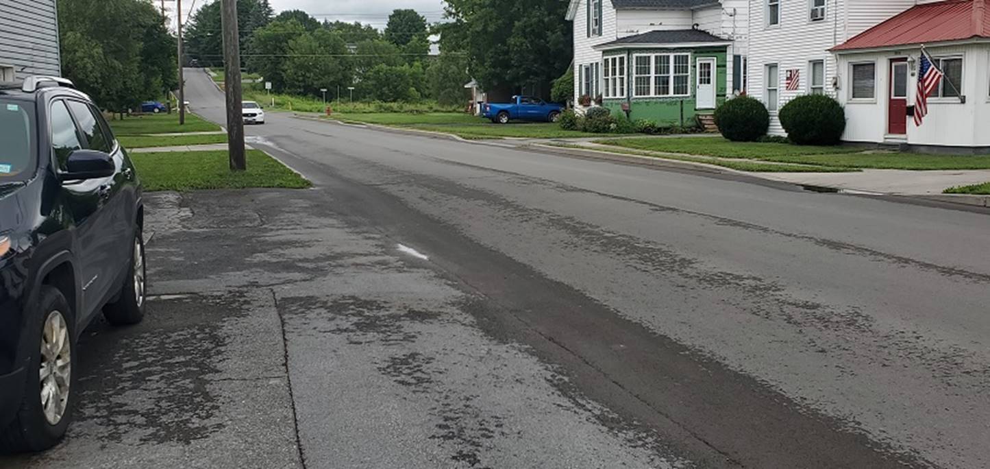 A road with a house and trees

Description automatically generated