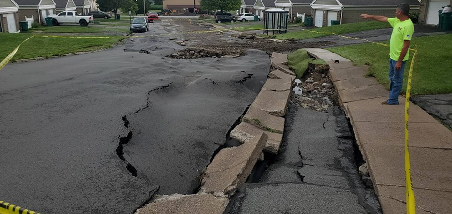 A large crack in the road

Description automatically generated