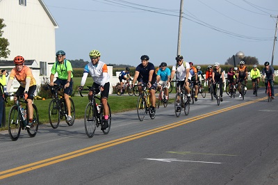 A group of people riding bicycles on a road

Description automatically generated