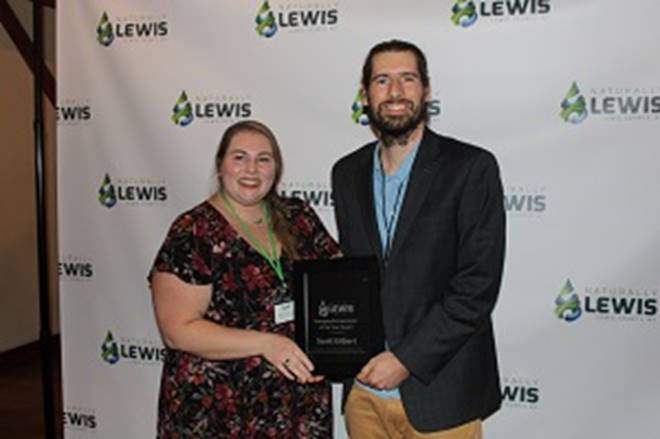 A person and person holding a plaque

Description automatically generated
