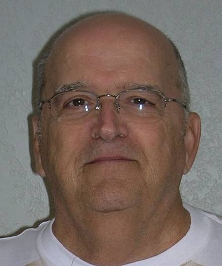 A close-up of a person wearing glasses

Description automatically generated