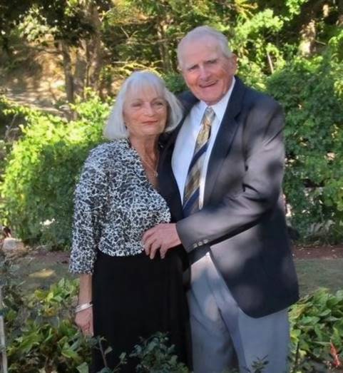 A person and person posing for a picture

Description automatically generated