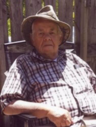 An old person sitting in a chair

Description automatically generated