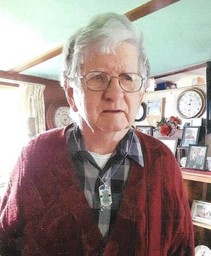 An old person wearing glasses

Description automatically generated