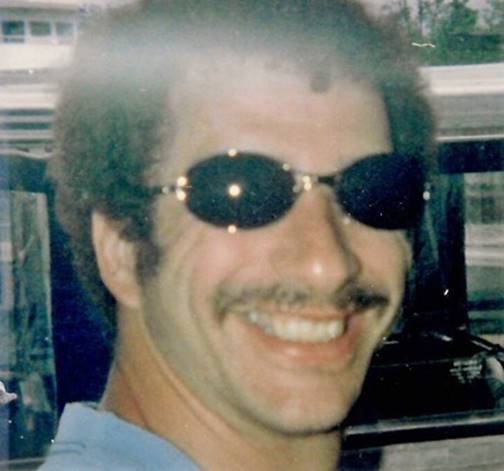 A person wearing sunglasses smiling

Description automatically generated