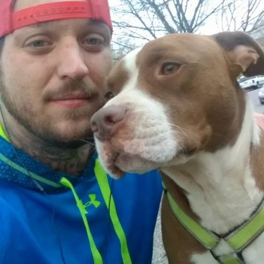 A person taking a selfie with a dog

Description automatically generated