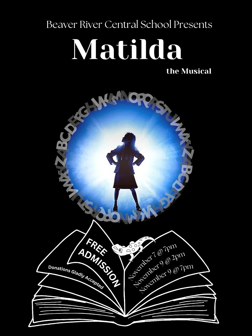 A person standing in front of a book

Description automatically generated