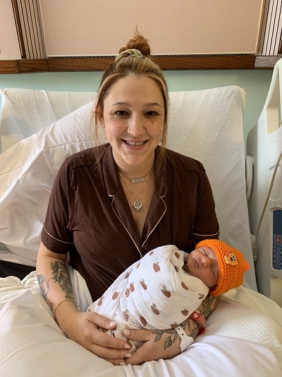 A person holding a baby

Description automatically generated
