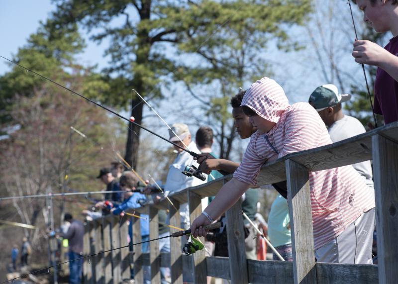People fishing off pier at six mile