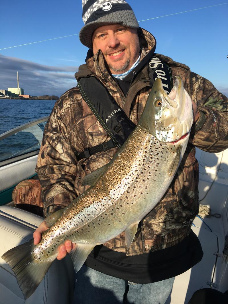 Person holding 16 lb Brook Trout on boat
