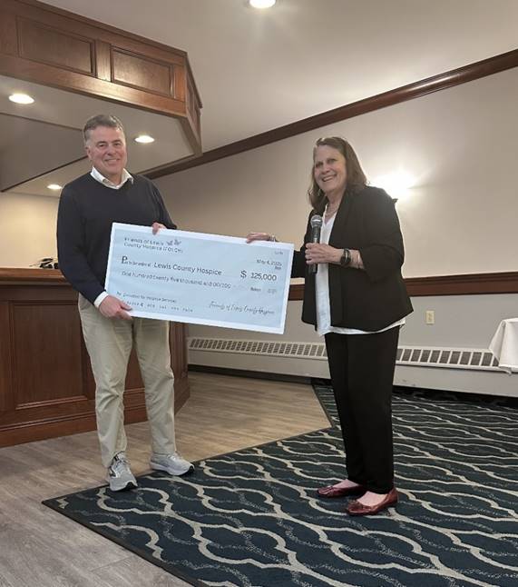 A person and person holding a large check

AI-generated content may be incorrect.