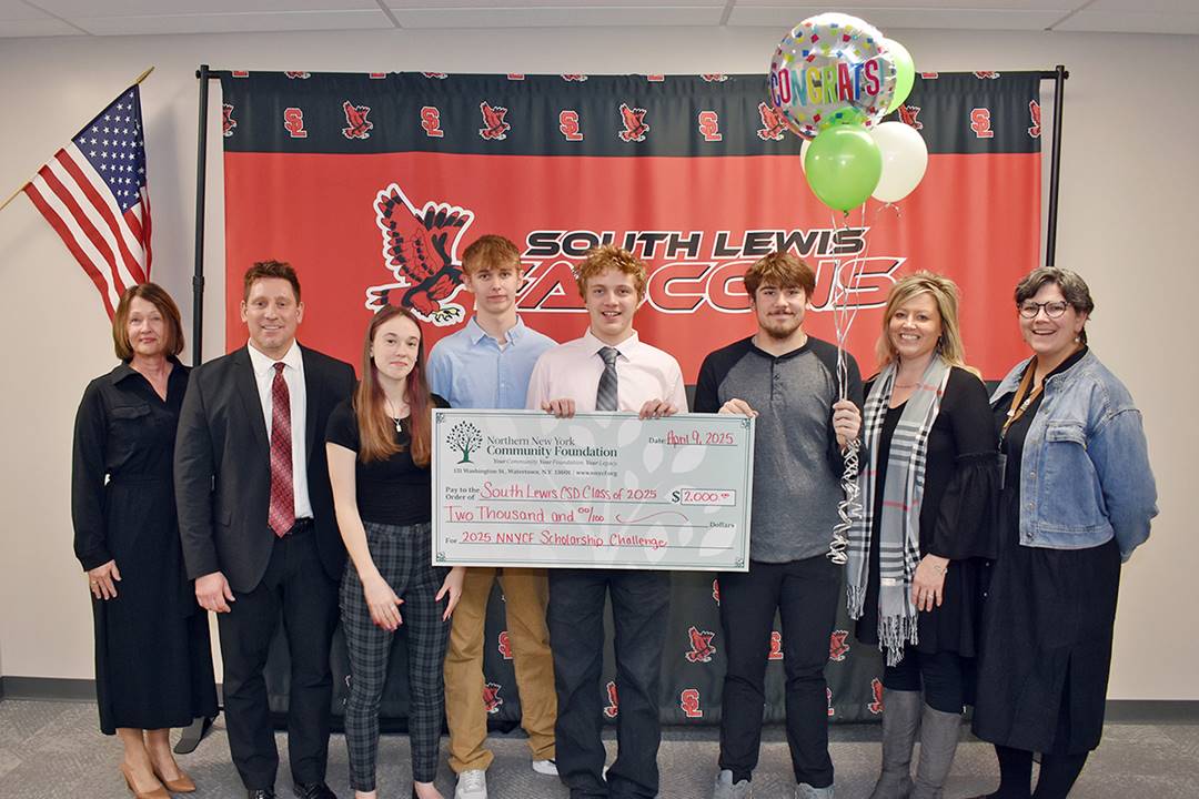 A group of people holding a check

AI-generated content may be incorrect.