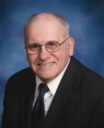 A person in a suit and tie

AI-generated content may be incorrect.