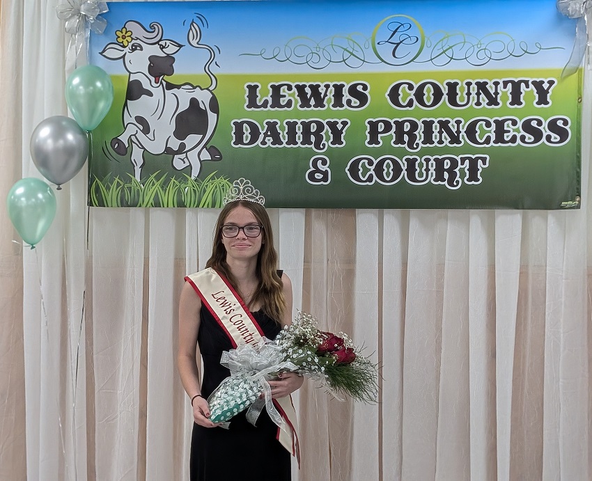 A person holding flowers and a banner

AI-generated content may be incorrect.