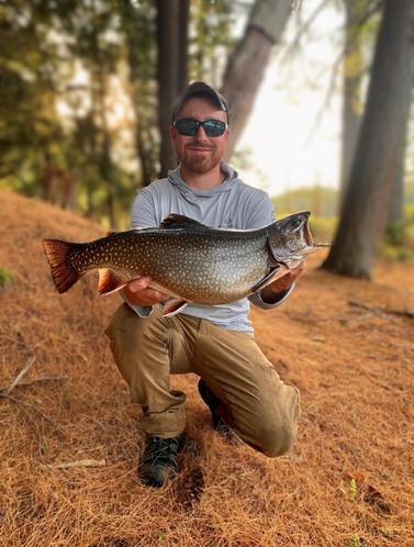 Benjamin Ferguson holding the new State record brook trout