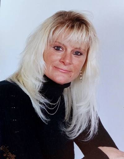 A person with blonde hair and black turtleneck

AI-generated content may be incorrect.