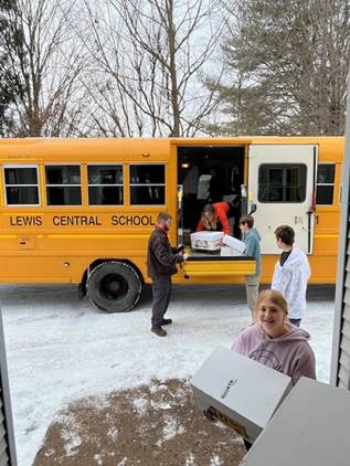 A group of people standing next to a school bus

AI-generated content may be incorrect.