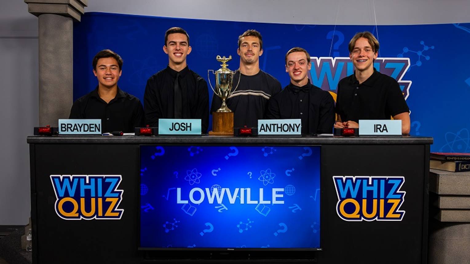 A group of men standing behind a table with a trophy

AI-generated content may be incorrect.