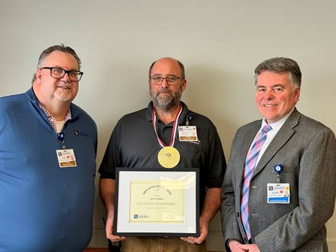 A group of men holding a framed award

AI-generated content may be incorrect.