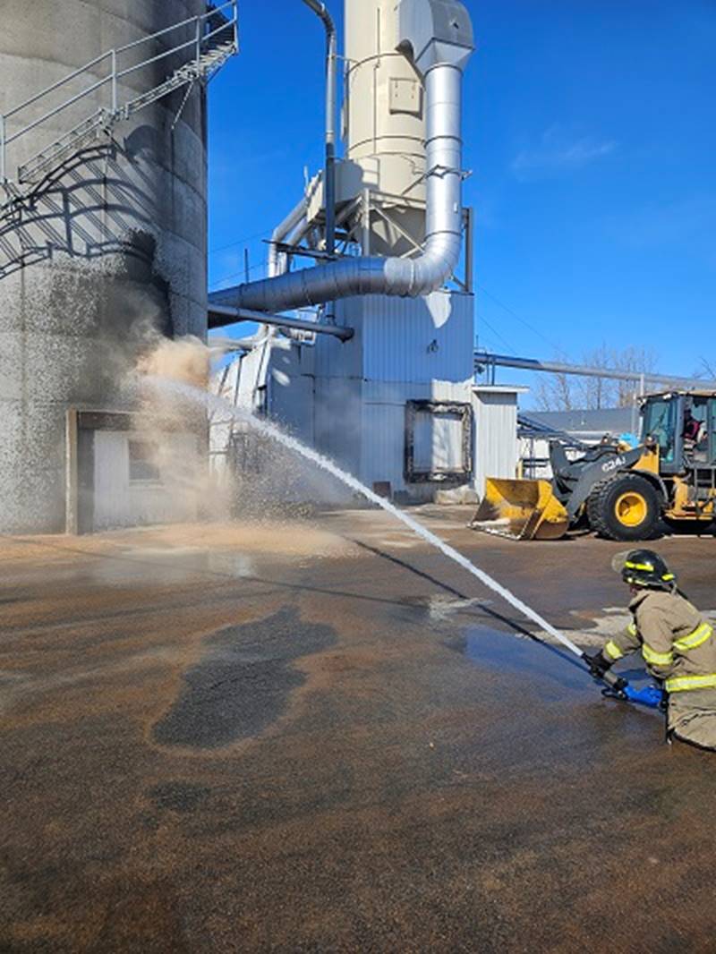 A firefighter spraying water on a concrete structure

AI-generated content may be incorrect.