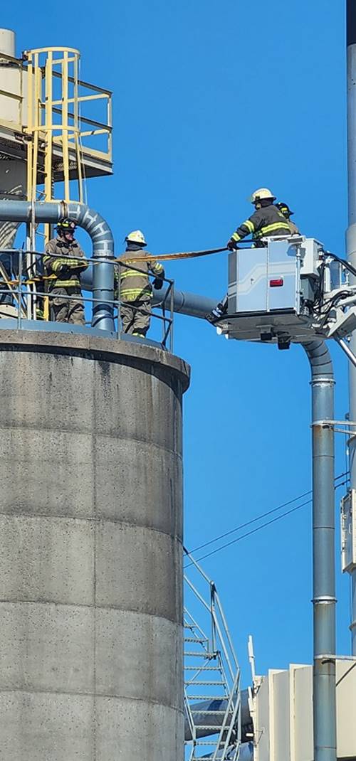 A group of firefighters on a crane

AI-generated content may be incorrect.