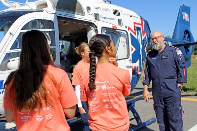 A group of people standing next to a helicopter

AI-generated content may be incorrect.