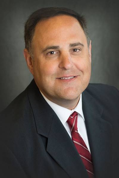 A close-up of a person in a suit

AI-generated content may be incorrect.