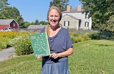 A person holding a book in her hand

AI-generated content may be incorrect.