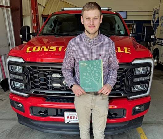 A person standing in front of a red truck

AI-generated content may be incorrect.