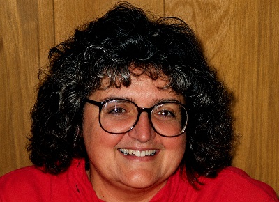 A person with curly hair wearing glasses

AI-generated content may be incorrect.