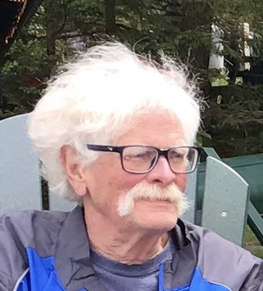 A person with white hair and glasses

AI-generated content may be incorrect.