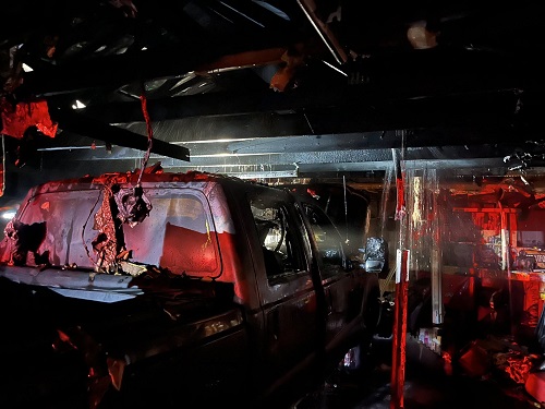 A truck in a garage with red paint

AI-generated content may be incorrect.