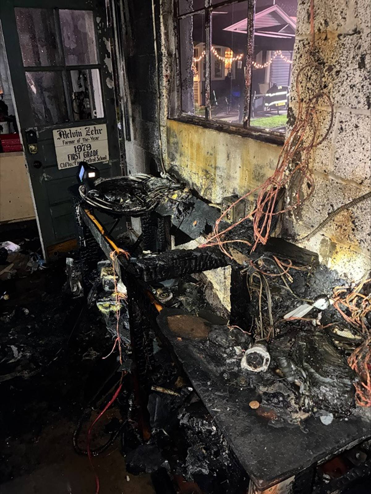 A burned out room with a door and a window

AI-generated content may be incorrect.