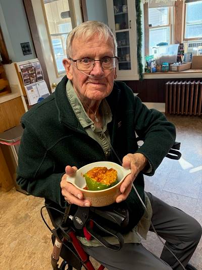 A person in a wheelchair holding a bowl of food

AI-generated content may be incorrect.