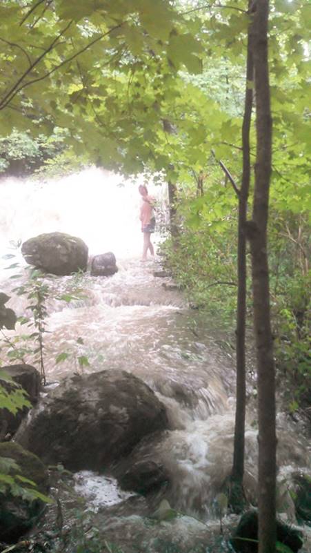 A person standing in a river

AI-generated content may be incorrect.